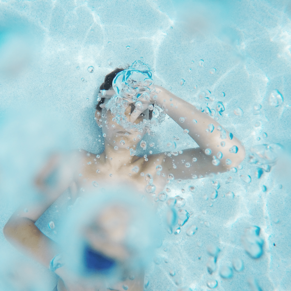Boy under water holding breath