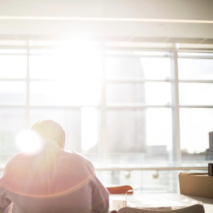 man sitting at table working