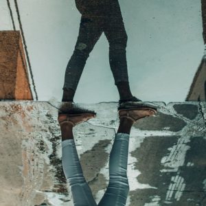 reflection of woman walking in the street