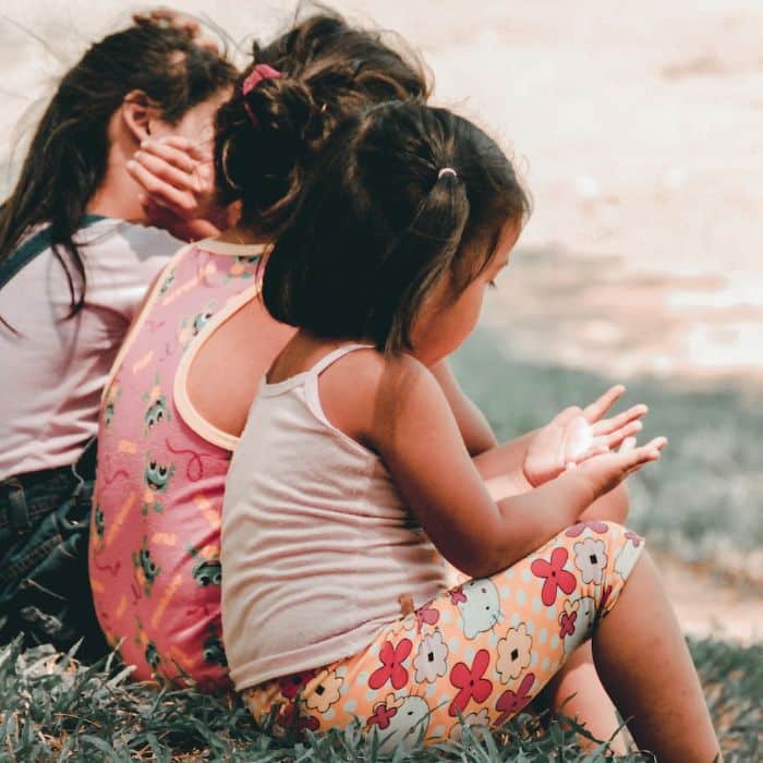 children sitting on the grass